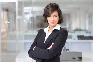 Business woman in an office. Crossed arms